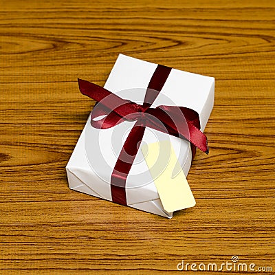 White gift box and red ribbin with tag
