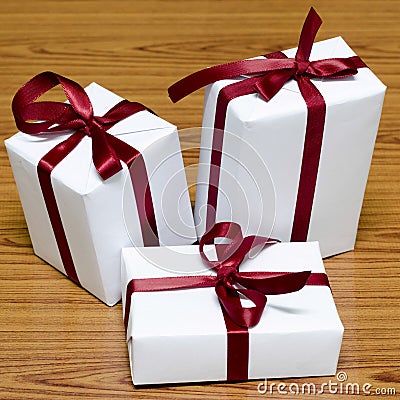 White gift box with red ribbin