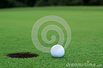 White golf ball on putting green
