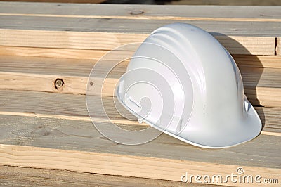 White Hard Hat on Lumber