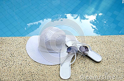 White hat shoes sunglasses pool blue water