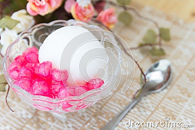White ice cream made from coconut and pink jelly topping on the