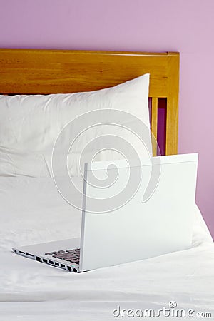 White laptop on bed