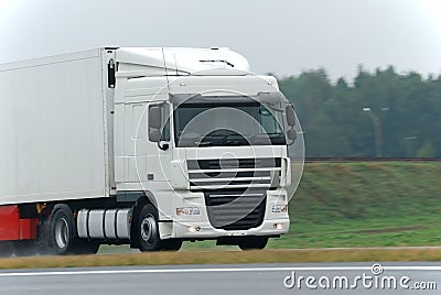 White lorry on wet road