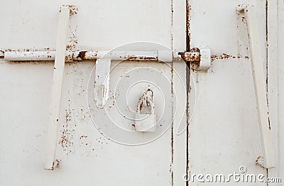 White metal door fragment with padlock