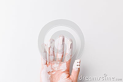 White painted hand over white background.