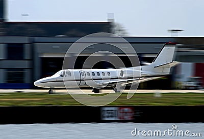 White private corporate jet taking off