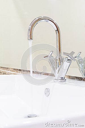 White sink washbasin and silver curve design faucet