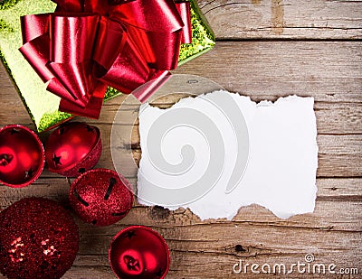 White torn paper on wooden background Christmas ornaments