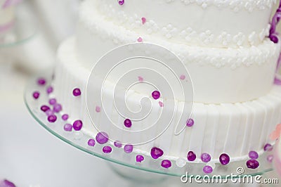 White wedding cake decorated with purple bubbles
