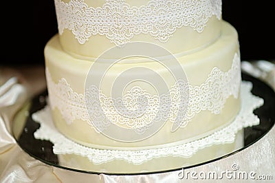 White wedding cake decorated with white lace