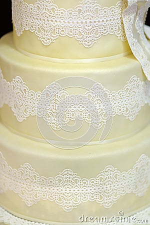 White wedding cake decorated with white lace