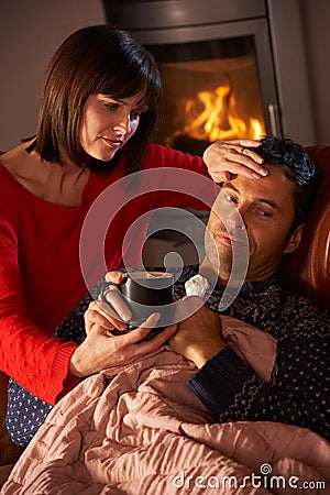 Wife Nursing Sick Husband With Cold