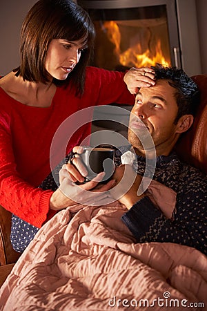 Wife Nursing Sick Husband With Cold