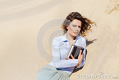 Wind hair student girl relaxing on the sand