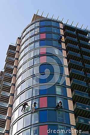 Window cleaners abseiling the building