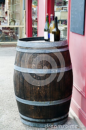 Wine barrel with wine bottles on top