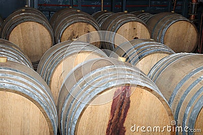 Wine barrels in arrangement waiting in a cellar