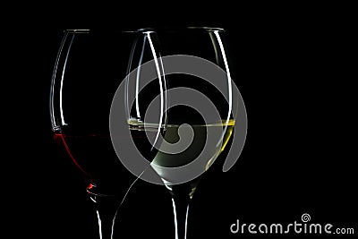 Wine glasses with red and white wine isolated on the black background