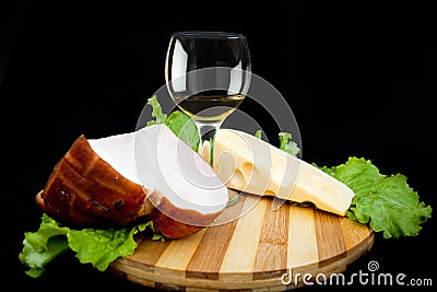 Wineglass of white wine cheese and ham