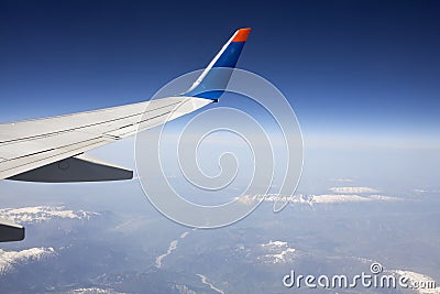 Wing of the plane on blue sky.