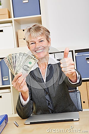Winning woman holding dollar bills