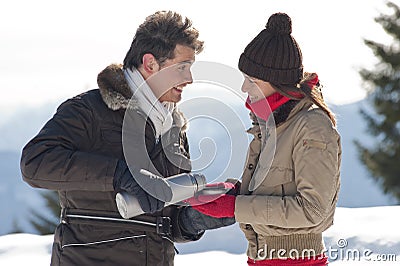 Winter couple with hot drinks