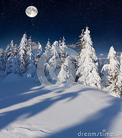Winter landscape in the mountains with full moon.
