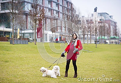 Winter portrait of pregnant woman walking dogs