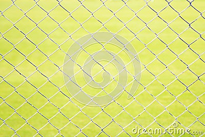 Wire Mesh Fence Close-Up on Green Background