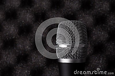 Wireless microphone closeup on foam acoustic background