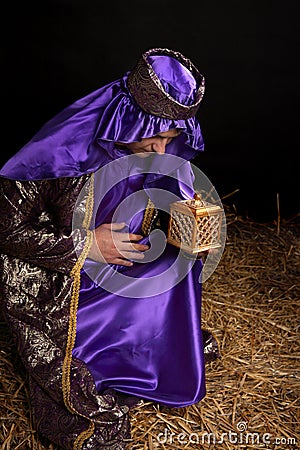 Wise man bowing holding gift