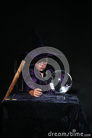 Wizard child with crystal ball and staff