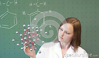 Woman analyzes a molecular model in lab