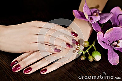 Woman applying nail varnish to finger nails