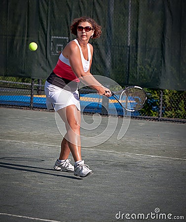 Woman athlete about to hit a tennis ball