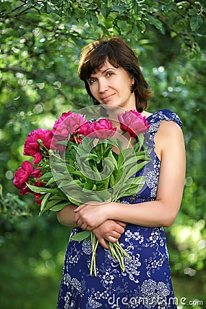 The woman of average years with flowers
