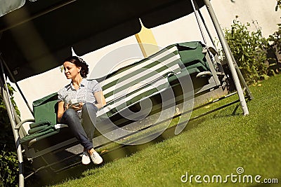 Woman in back yard on bench