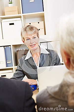 Woman in bank talking to customers