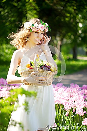 Woman with a basket of fruit in hand