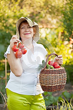 Woman with basket of harvested vegetables