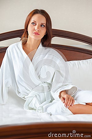 Woman in bathrobe waking up