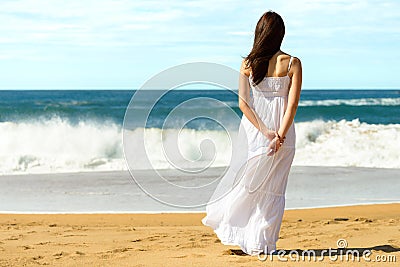 Woman on beach looking the sea