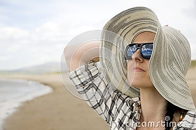 Woman on beach with sun hat