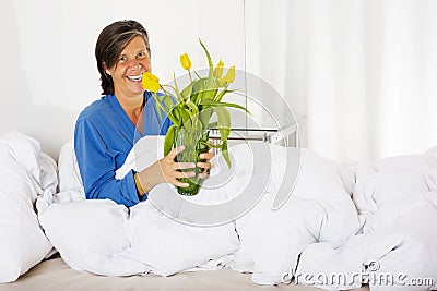 Woman in bed with flowers