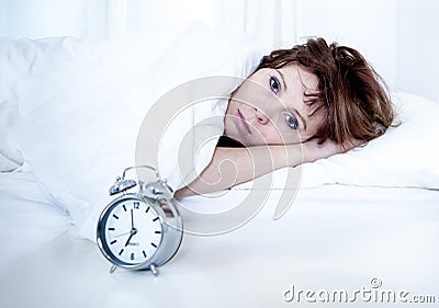 Woman in bed with insomnia that can t sleep with alarm clock