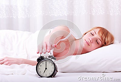 Woman in bed trying to wake up
