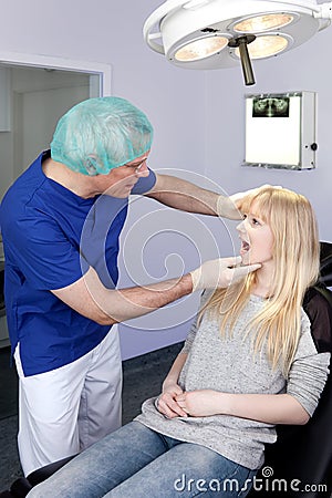 Woman being examined by a Dental-Surgeon.