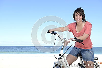 Woman with bike on the beach