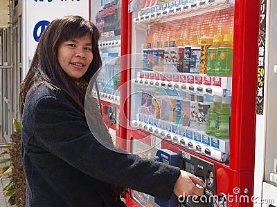 Woman buying coffee in vending machine